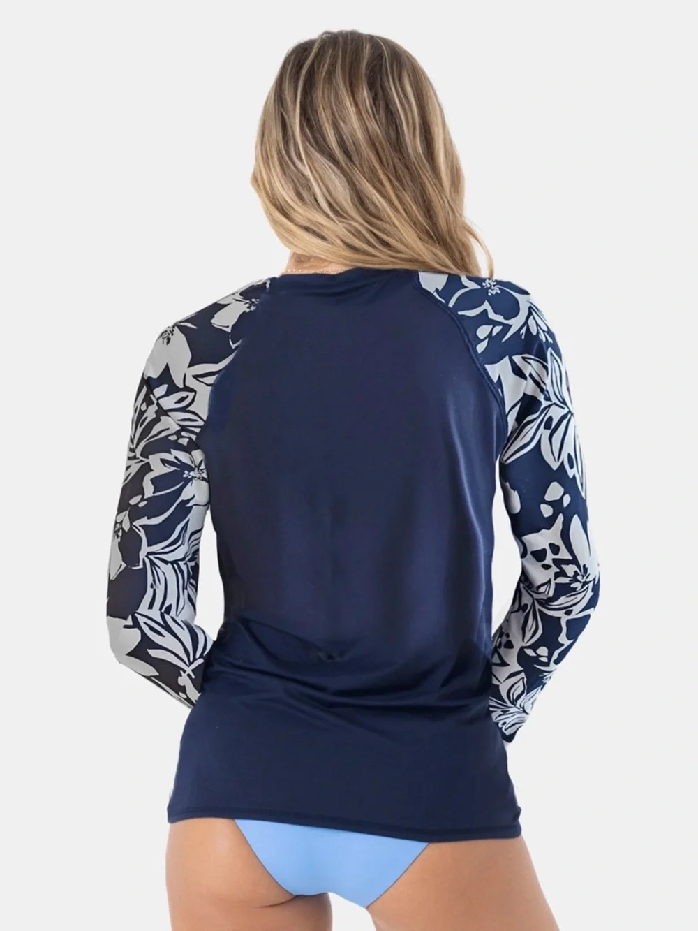 Roxy rashguard in blue with white floral design at sleeves